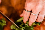rippling water silver ring band on hands cutting greens in kitchen